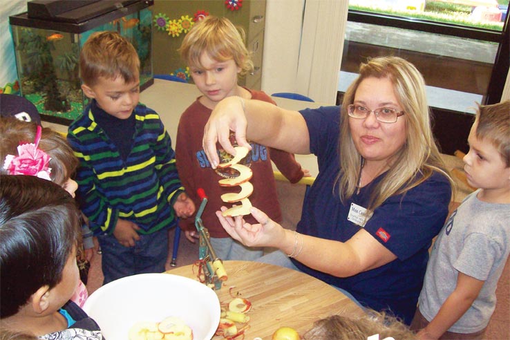 Children interacting with a teacher.